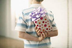 Boy Hiding Gift Behind His Back